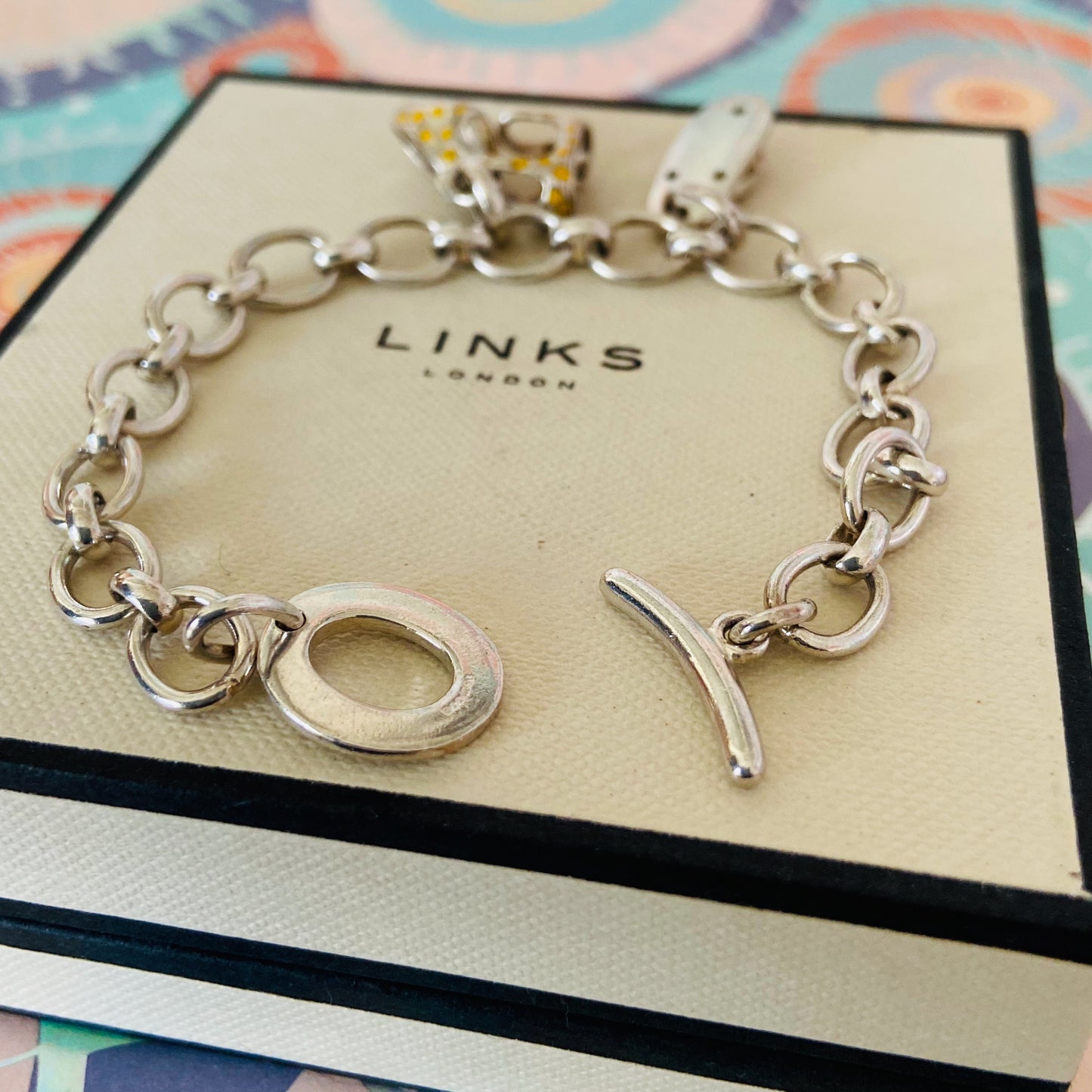 Links of London T-Bar Signature Bracelet with a Flip Flop and Yellow Polka Dot Bikini.