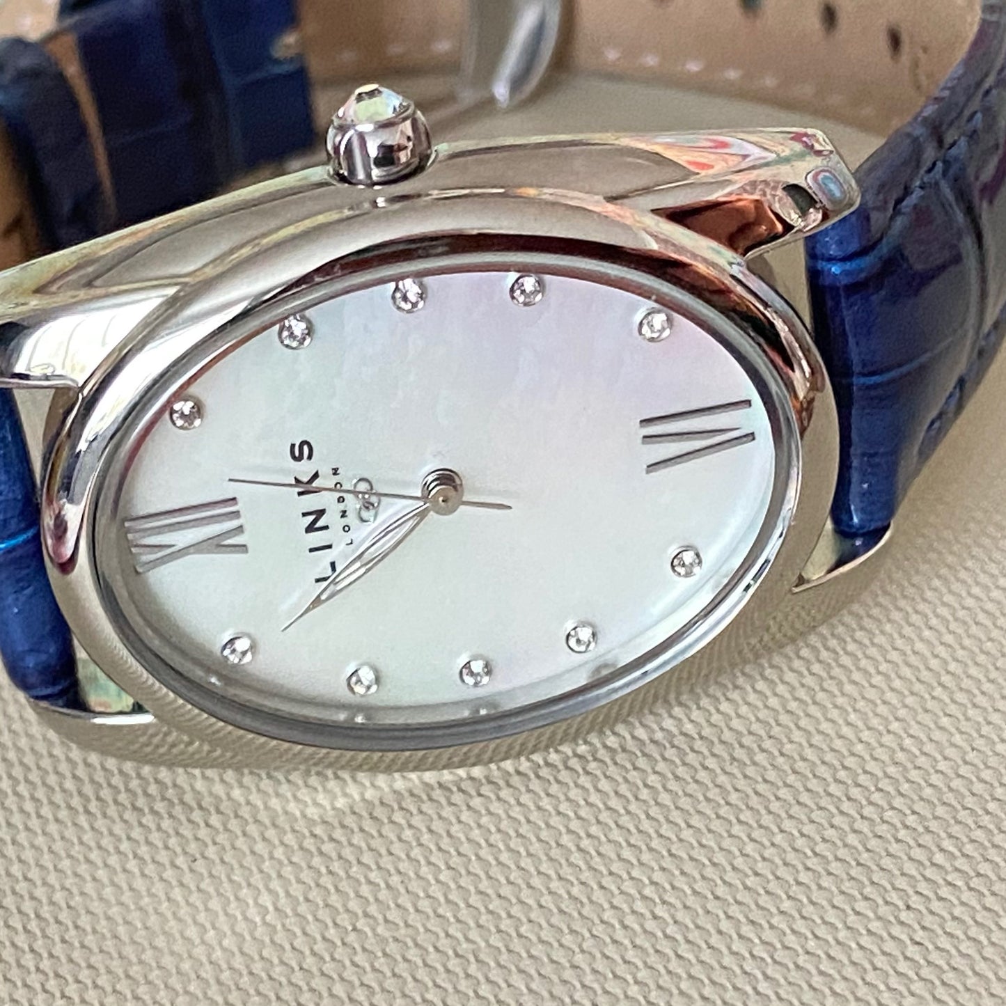 Rare Links of London Driver Ellipse Watch with Mother of pearl face, 10 Sapphire Crystals a Blue Real Leather Strap.