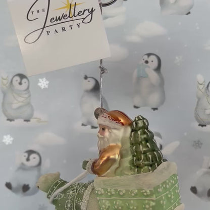festive tabletop ornament features Santa riding a sleigh