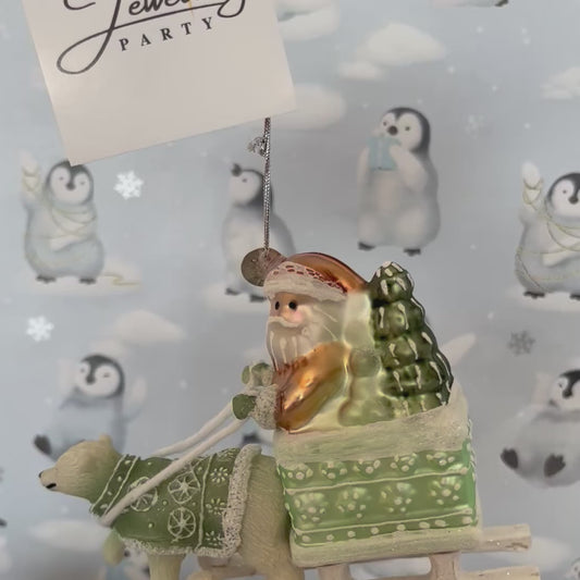 festive tabletop ornament features Santa riding a sleigh